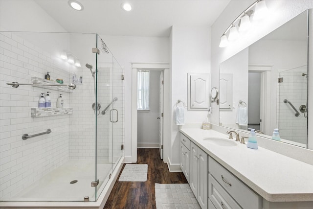 1170 Woody Ln, Sealy, TX 77474 - full bathroom with wood finished floors, a shower stall, vanity, recessed lighting, and baseboards