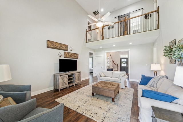 1170 Woody Ln, Sealy, TX 77474 - living area featuring stairway, a towering ceiling, wood finished floors, baseboards, and a ceiling fan