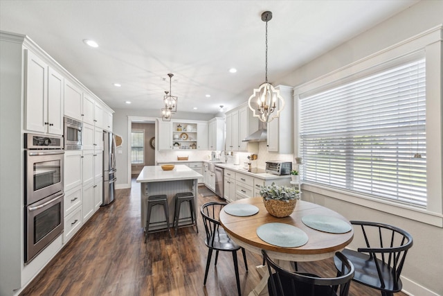 1170 Woody Ln, Sealy, TX 77474 - dining room featuring a chandelier, healthy amount of natural light, recessed lighting, dark wood-style floors, and baseboards