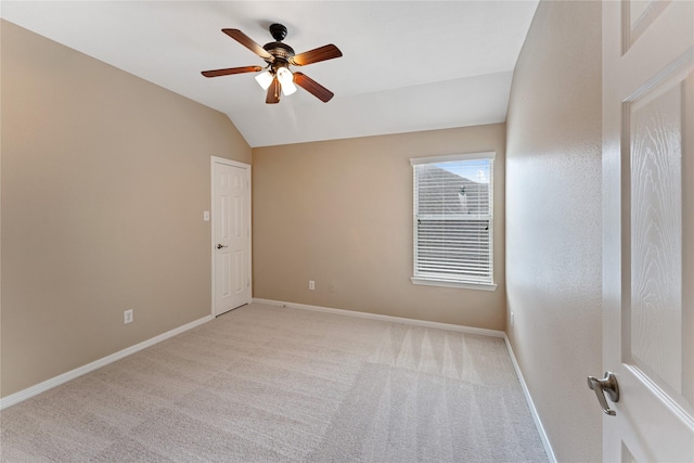 12314 Shore Lands Rd, Cypress, TX 77433 - spare room with a ceiling fan, vaulted ceiling, light colored carpet, and baseboards