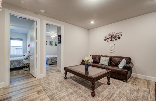 10014 Knollwood Ln, Missouri City, TX 77459 - living room featuring light wood-style flooring, baseboards, and ceiling fan