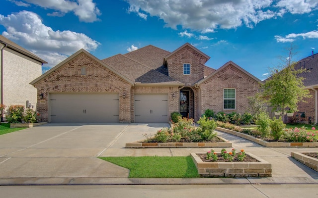 10014 Knollwood Ln, Missouri City, TX 77459 - view of front facade with brick siding, a garage, driveway, and roof with shingles