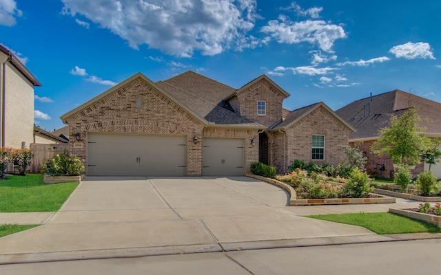 10014 Knollwood Ln, Missouri City, TX 77459 - view of front of house featuring brick siding, an attached garage, driveway, roof with shingles, and fence