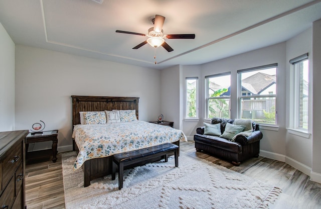 10014 Knollwood Ln, Missouri City, TX 77459 - bedroom featuring multiple windows and wood finished floors
