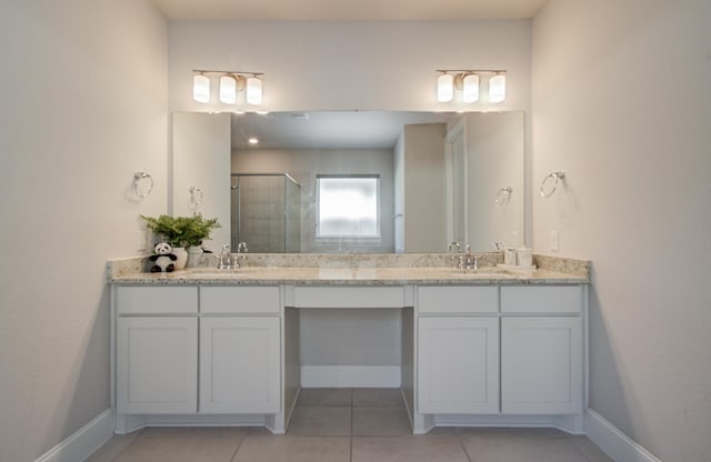 10014 Knollwood Ln, Missouri City, TX 77459 - full bathroom featuring tile patterned floors, a shower stall, double vanity, and baseboards
