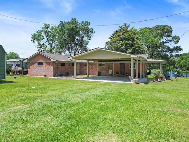 135 Sweetgum St, Trinity, TX 75862 - rear view of property featuring brick siding, an attached carport, and a yard
