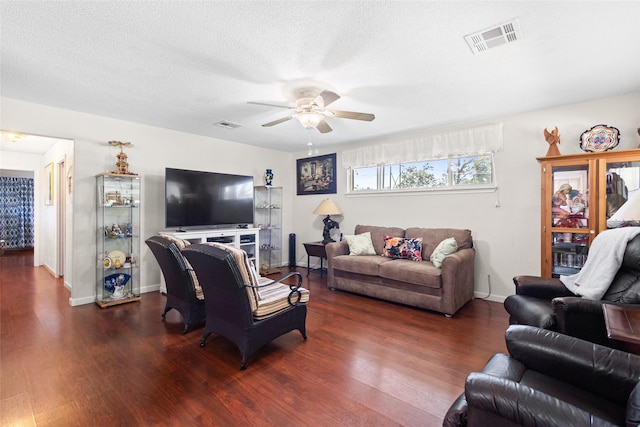 135 Sweetgum St, Trinity, TX 75862 - living area with ceiling fan, dark wood finished floors, baseboards, and a textured ceiling