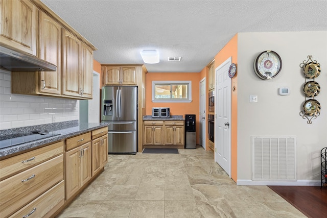 135 Sweetgum St, Trinity, TX 75862 - kitchen with stainless steel refrigerator with ice dispenser, oven, black electric stovetop, dark stone countertops, and a textured ceiling
