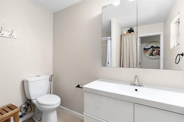 135 Sweetgum St, Trinity, TX 75862 - bathroom featuring toilet, tile patterned floors, baseboards, and vanity