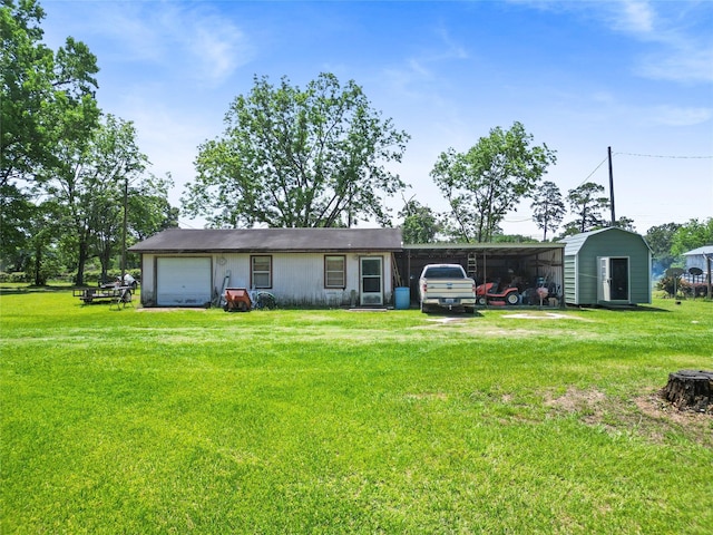 135 Sweetgum St, Trinity, TX 75862 - back of house with a lawn, a carport, driveway, and a storage unit