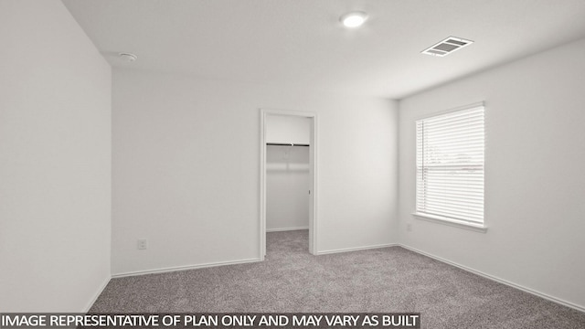 534 Belle Springs Ln, Conroe, TX 77301 - unfurnished bedroom featuring carpet flooring, a walk in closet, and baseboards