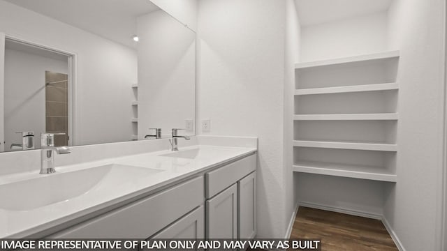 534 Belle Springs Ln, Conroe, TX 77301 - bathroom featuring wood finished floors, double vanity, and baseboards