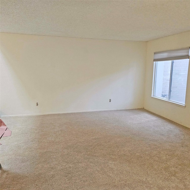2325 Crescent Park Dr Unit 277, Houston, TX 77077 - spare room featuring carpet flooring, a textured ceiling, and baseboards