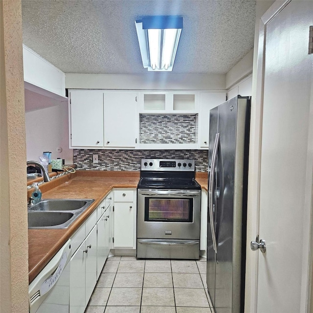2325 Crescent Park Dr Unit 277, Houston, TX 77077 - kitchen with appliances with stainless steel finishes, a sink, white cabinets, decorative backsplash, and a textured ceiling