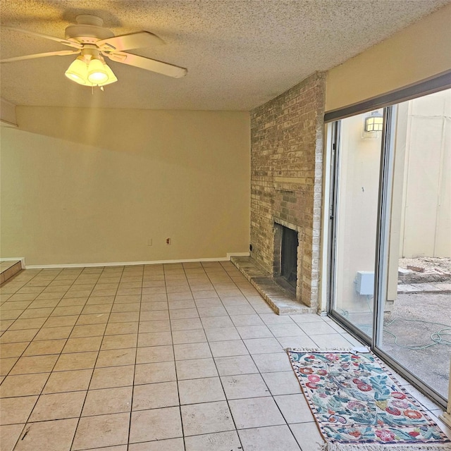 2325 Crescent Park Dr Unit 277, Houston, TX 77077 - unfurnished living room with a textured ceiling, a fireplace, a ceiling fan, and light tile patterned floors