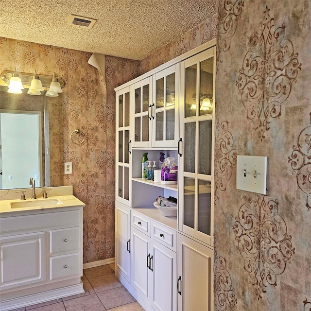 2325 Crescent Park Dr Unit 277, Houston, TX 77077 - bathroom with wallpapered walls, tile patterned flooring, baseboards, and vanity