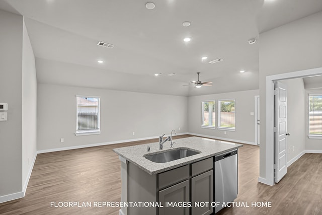 4981 Perennial Ln, La Marque, TX 77568 - kitchen featuring stainless steel dishwasher, a sink, open floor plan, wood finished floors, and gray cabinets
