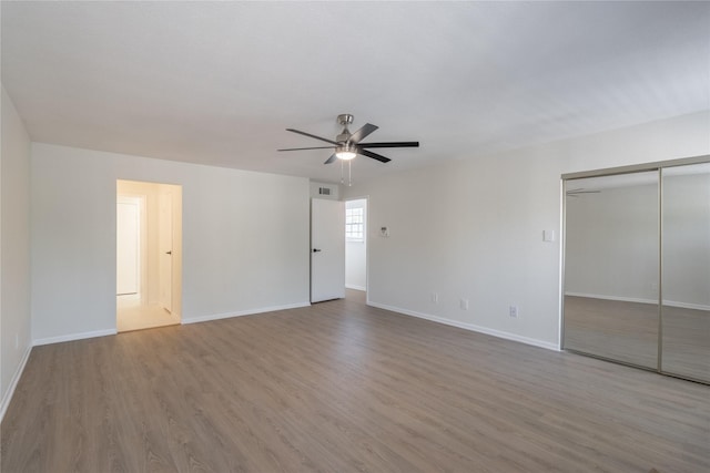 9850 Pagewood Ln Unit 909, Houston, TX 77042 - unfurnished bedroom with wood finished floors, baseboards, a closet, and a ceiling fan