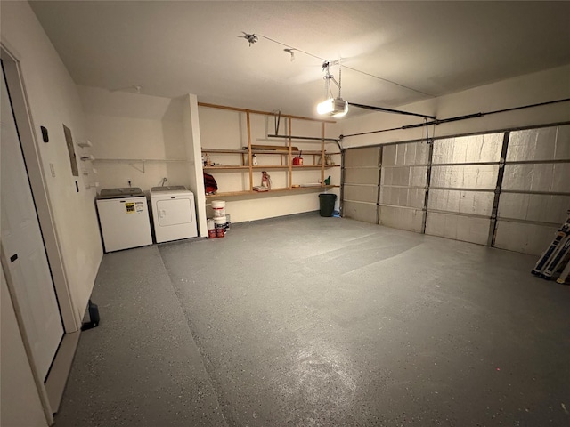 9850 Pagewood Ln Unit 909, Houston, TX 77042 - garage featuring a garage door opener and washer and clothes dryer