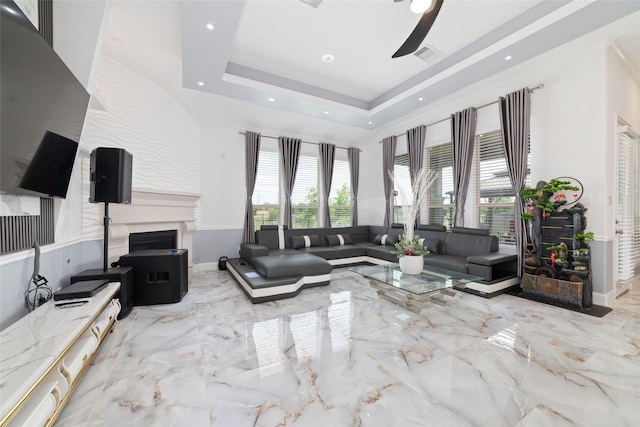 8007 Clearwater Glen Ct, Richmond, TX 77407 - living room with marble tiled floors, a fireplace, a ceiling fan, a tray ceiling, and recessed lighting