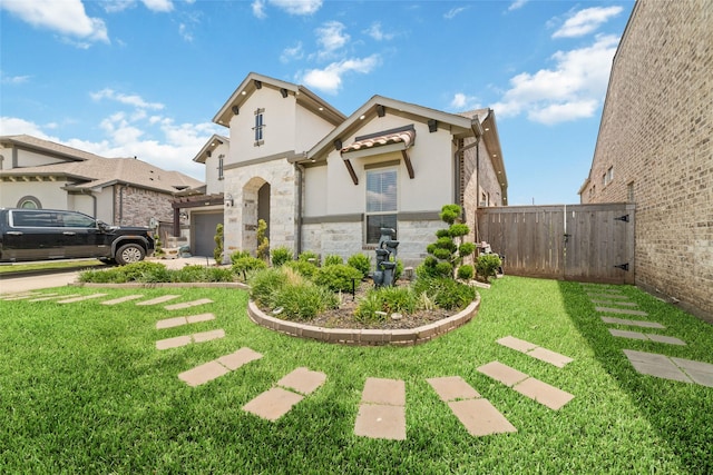 8007 Clearwater Glen Ct, Richmond, TX 77407 - view of front facade featuring stone siding, a gate, stucco siding, and an attached garage