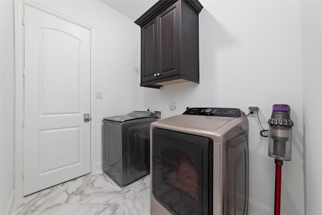 8007 Clearwater Glen Ct, Richmond, TX 77407 - laundry area featuring cabinet space, washing machine and dryer, light marble finish floors, and baseboards