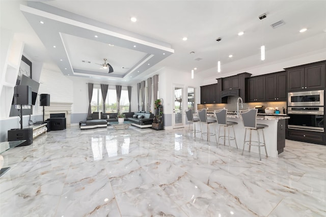 8007 Clearwater Glen Ct, Richmond, TX 77407 - kitchen with stainless steel appliances, open floor plan, a breakfast bar, dark brown cabinetry, and recessed lighting