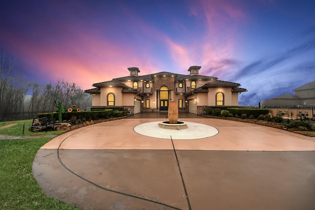 11503 Renaissance Dr, Montgomery, TX 77356 - mediterranean / spanish home with curved driveway, a chimney, stucco siding, fence, and a tile roof