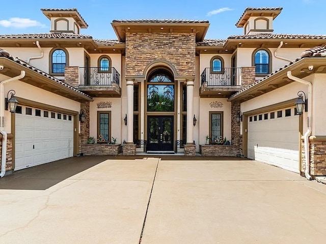11503 Renaissance Dr, Montgomery, TX 77356 - mediterranean / spanish home with a balcony, french doors, and stone siding