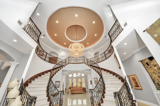 11503 Renaissance Dr, Montgomery, TX 77356 - foyer featuring a high ceiling, decorative columns, arched walkways, recessed lighting, and stairs