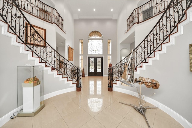 11503 Renaissance Dr, Montgomery, TX 77356 - foyer entrance featuring a high ceiling, stairway, baseboards, tile patterned flooring, and french doors