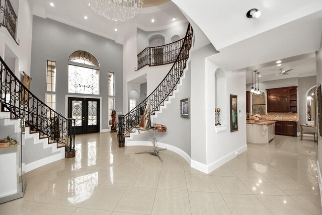 11503 Renaissance Dr, Montgomery, TX 77356 - foyer entrance featuring stairway, french doors, arched walkways, baseboards, and a high ceiling