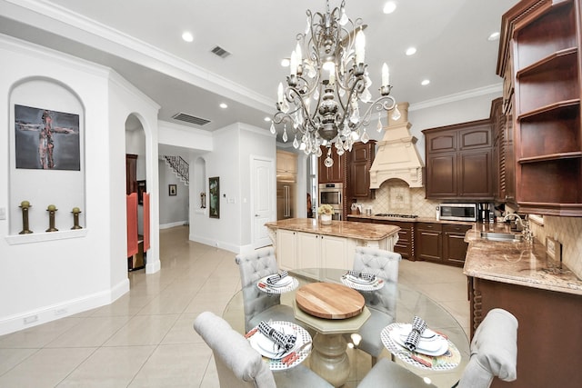11503 Renaissance Dr, Montgomery, TX 77356 - dining space featuring light tile patterned floors, arched walkways, baseboards, recessed lighting, and a chandelier