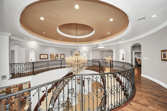 11503 Renaissance Dr, Montgomery, TX 77356 - hallway featuring a raised ceiling, a chandelier, arched walkways, ornate columns, and recessed lighting
