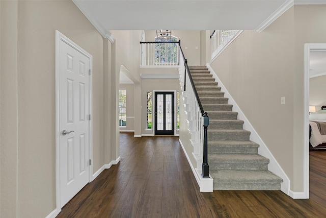 2833 Everett Dr, Friendswood, TX 77546 - entrance foyer with wood finished floors, baseboards, arched walkways, stairs, and crown molding