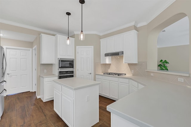 2833 Everett Dr, Friendswood, TX 77546 - kitchen with stainless steel appliances, white cabinets, light countertops, backsplash, and a kitchen island