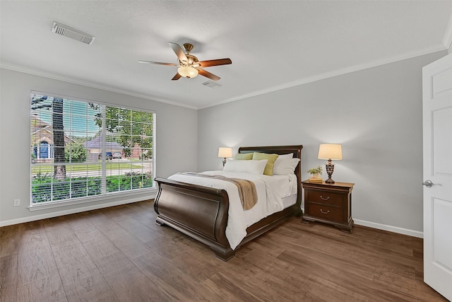 2833 Everett Dr, Friendswood, TX 77546 - bedroom with crown molding, dark wood finished floors, baseboards, and a ceiling fan