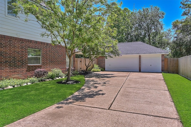 2833 Everett Dr, Friendswood, TX 77546 - view of front of property with brick siding, an outdoor structure, a detached garage, and roof with shingles