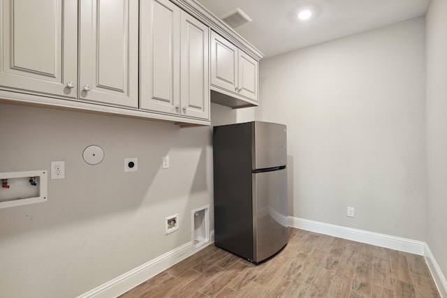 29407 Amber Meadows Ct, Katy, TX 77494 - clothes washing area featuring hookup for an electric dryer, cabinet space, washer hookup, baseboards, and light wood-style floors