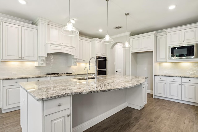 29407 Amber Meadows Ct, Katy, TX 77494 - kitchen with appliances with stainless steel finishes, a sink, dark wood-style flooring, decorative backsplash, and recessed lighting