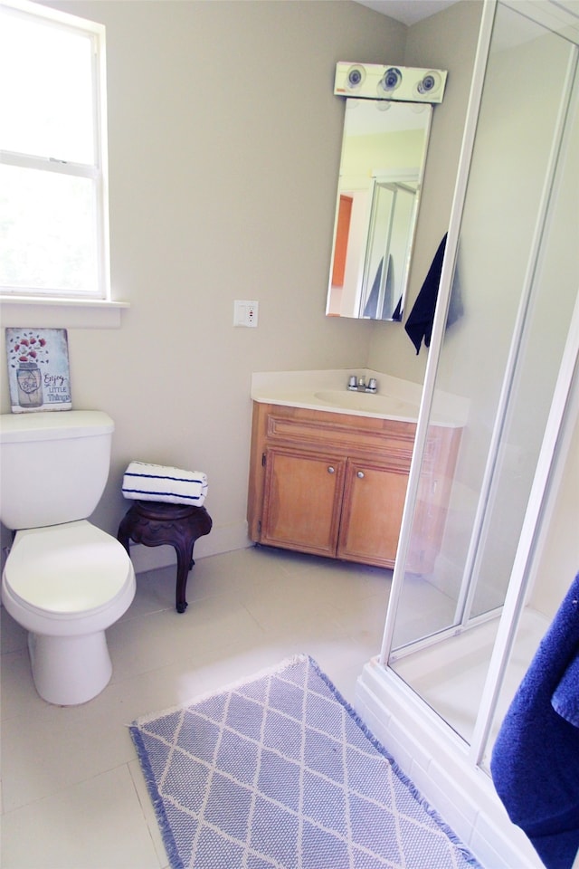 full bathroom featuring a shower stall, vanity, toilet, and tile patterned floors