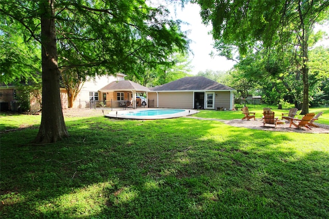 rear view of property with a fire pit, a gazebo, and a patio