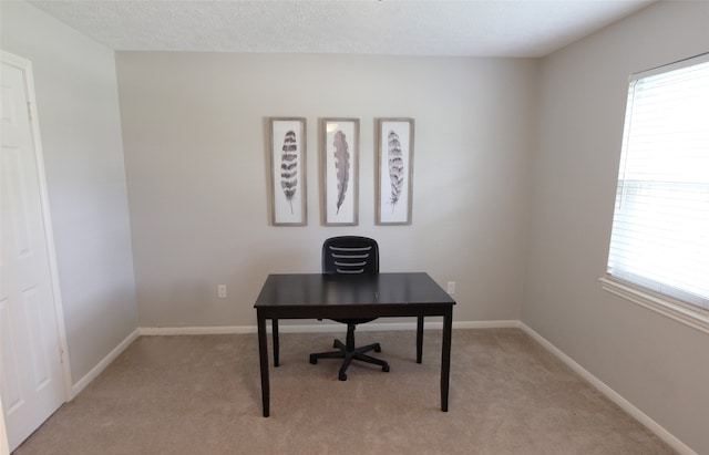 office space with light colored carpet and baseboards