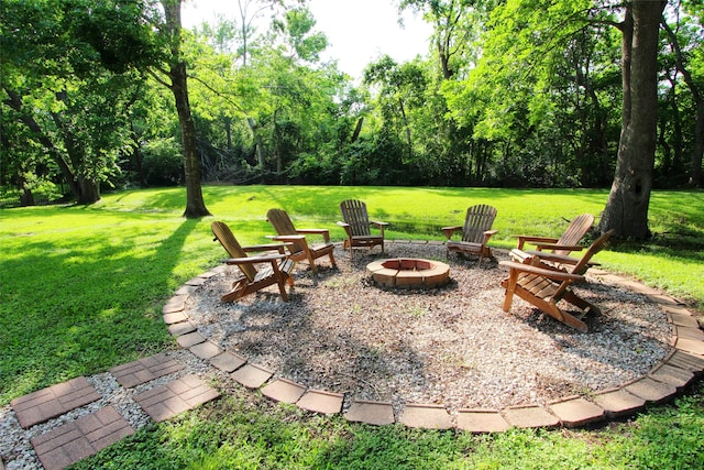 view of grassy yard featuring an outdoor fire pit