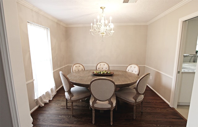 dining space with a chandelier, wood finished floors, crown molding, and baseboards