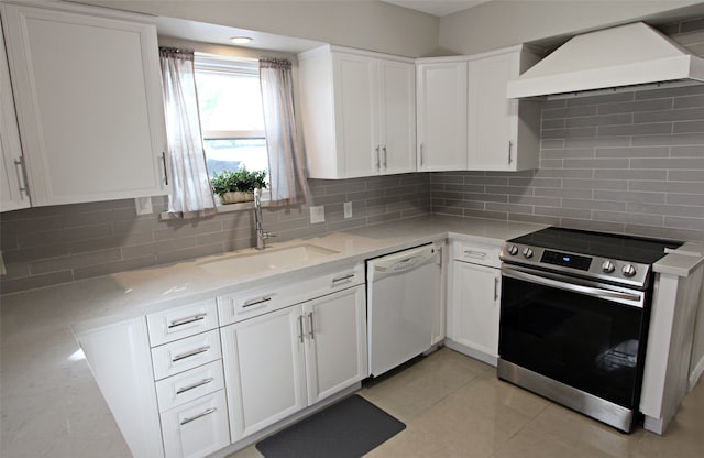 kitchen with stainless steel electric stove, dishwasher, a sink, custom exhaust hood, and white cabinetry