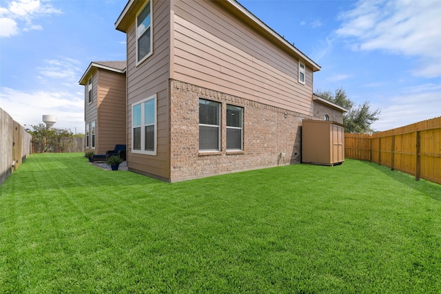 1078 Lasso Ct, Alvin, TX 77511 - rear view of property with a storage unit, brick siding, and an outbuilding