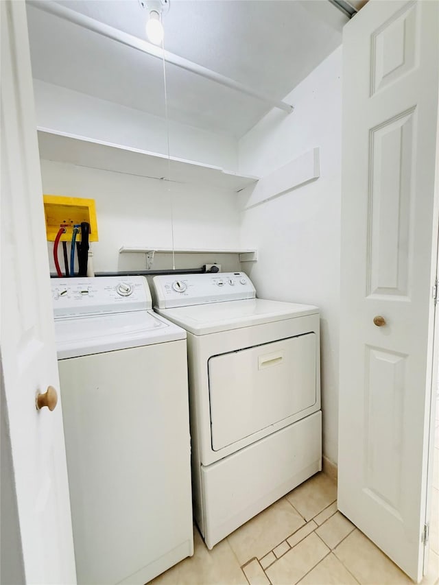 6405 Westward St Unit 96, Houston, TX 77081 - clothes washing area featuring independent washer and dryer and light tile patterned floors