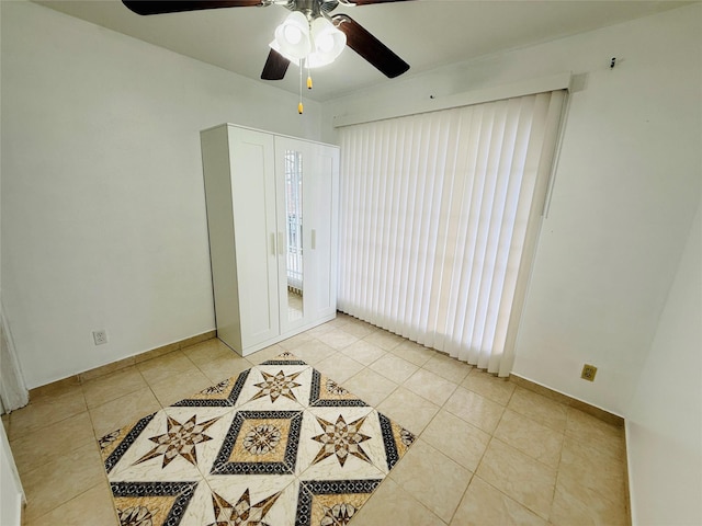 6405 Westward St Unit 96, Houston, TX 77081 - unfurnished room with light tile patterned floors, ceiling fan, and baseboards