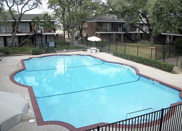 6405 Westward St Unit 96, Houston, TX 77081 - community pool featuring stairs and fence